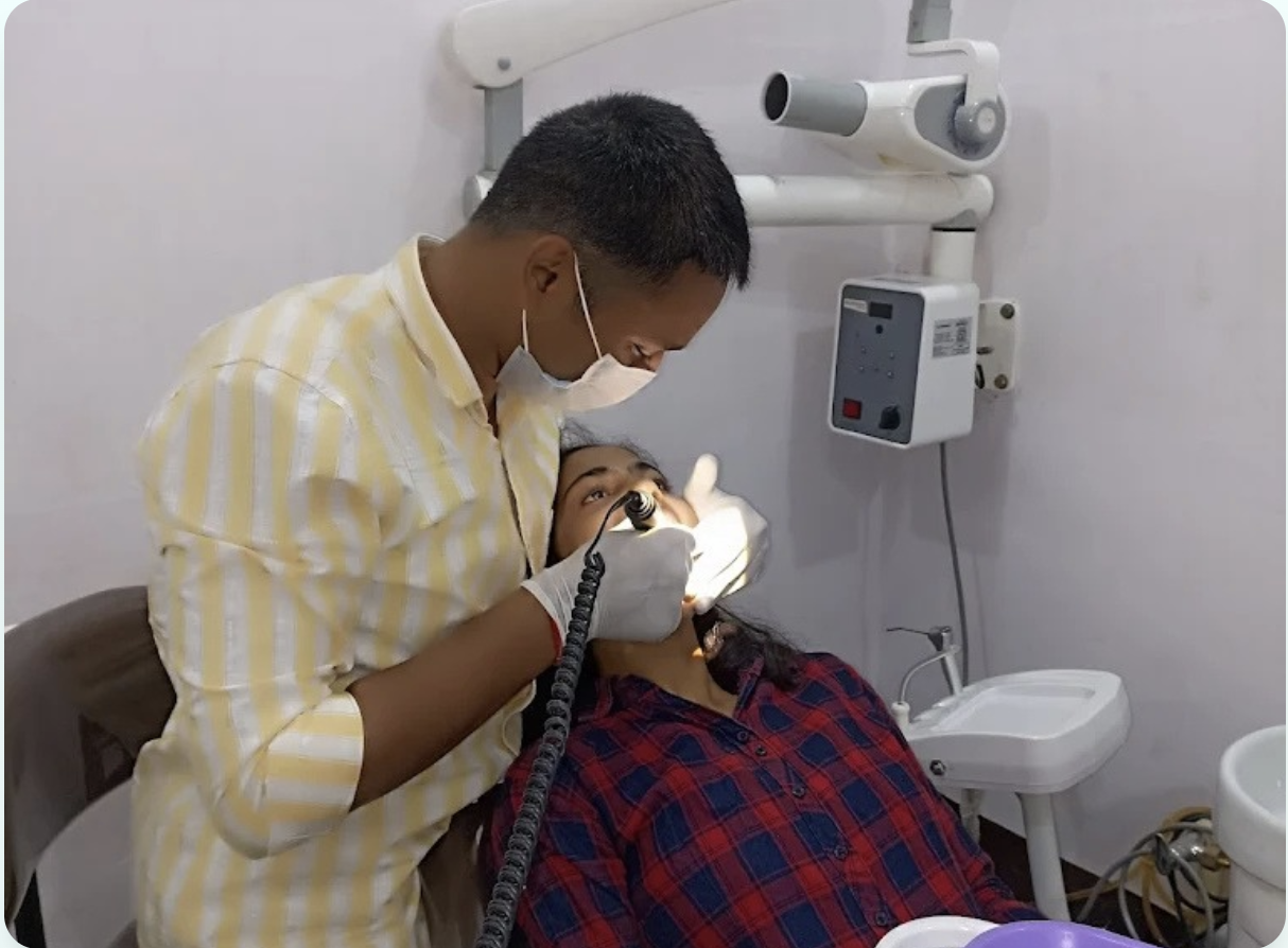 Dentist treating a patient at Siddhivinayak Dental Hospital