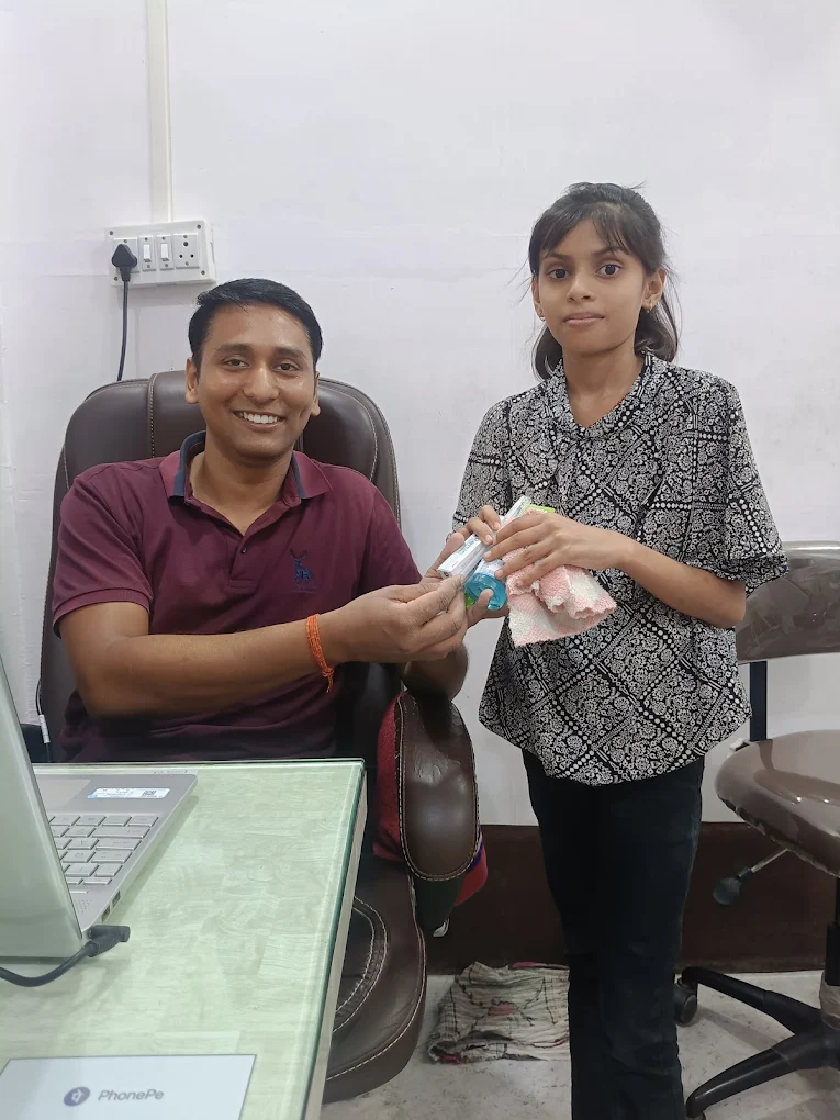 Dentist with a young patient after her visit